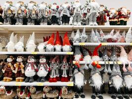 Podgorica, Montenegro - 25 december 2022. Statuettes of Santa Claus, gnomes and snowmen on store shelves photo