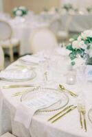 Festive menu on a plate surrounded by golden cutlery on the table photo