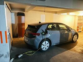 Kotor, Montenegro - 25 december 2022. Electric car is charging in a lit room photo