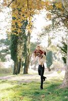 Mom throws a little girl up while standing in the forest photo