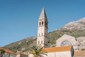 campana torre de el Iglesia de S t. nicholas en contra el fondo de el montañas. peras, montenegro foto