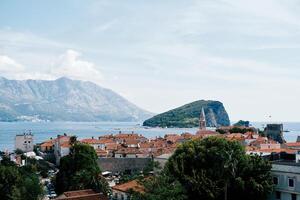 Old town of Budva on the seashore with the island of Sveti Nikola in the background. Montenegro photo