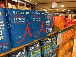 Herceg-Novi, Montenegro - 17 august 2023. Shelves with colorful French dictionaries in a bookstore photo