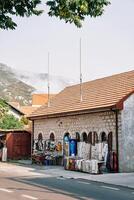 Counter with warm blankets, knitted clothes near a souvenir shop at the foot of the mountains photo