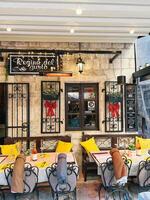 Kotor, Montenegro - 25 december 2022. Tables with chairs stand in front of the old restaurant. Caption. Regina del gusto photo