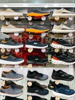 Budva, Montenegro - 25 december 2022. Assortment of men sneakers on the shelves in the store photo