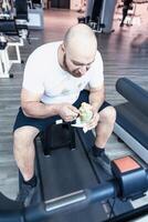 runner athlete relaxing eating an ice cream on the driving machinery photo