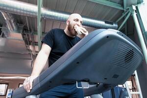 runner athlete relaxing eating a sandwich on the driving machinery photo