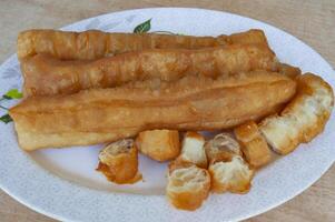 Top view of cakoi or Youtiao on white plate. Asian food concept photo