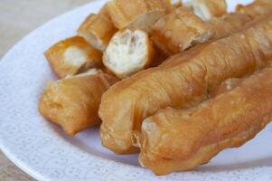Delicious cakoi or youtiao cake on white plate. Asian food concept photo