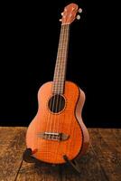 Ukulele Hawaiian guitar on wooden backgroun close up photo