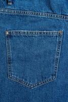 Back side and pockets of blue jeans pants close-up background photo