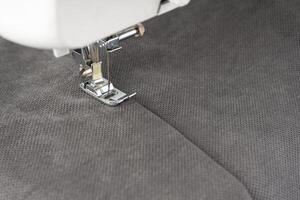 Modern sewing machine with gray fabric photo