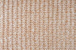 Jersey textile background , beige white melange knitted fabric, cloth surface photo