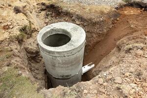 Installation of underground tank for sewage system photo
