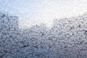 frosty pattern on window closeup and city building photo