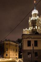 houses and skyscraper in Moscow city in night photo