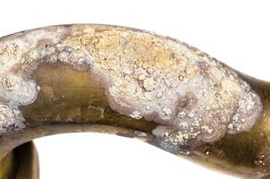 salt deposits on brass drain pipe closeup isolated photo