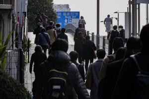 A crowd of walking people on the city street photo