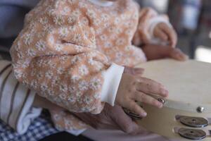 Child's hands with tambourine in the living room closeup photo