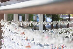 A fortune telling slip at Tomioka Shrine closeup photo