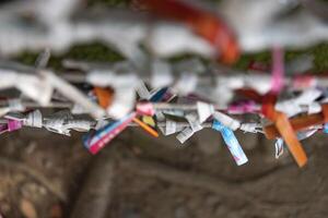 A fortune telling slip at Tomioka Shrine closeup photo