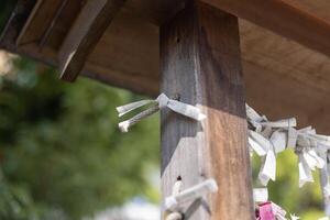 A fortune telling slip at Tomioka Shrine closeup photo