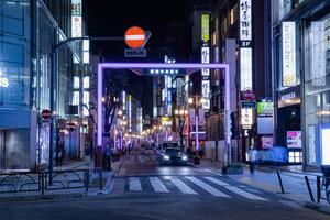 A night cityscape of the crowd at the neon town in Shinjuku Tokyo photo