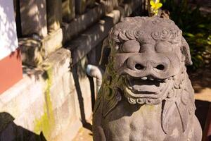 A guardian statue at Tomioka Shrine with copyspace photo