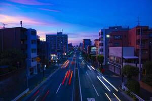 A traffic jam at the street in Setagaya Tokyo at dusk wide shot photo