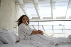 Young woman in bed, looking side, suffering from depression, mental health problem, insomnia, sleeping disorder, photo