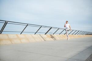 Full length portrait young athletic woman running jogging in the promenade in the morning photo