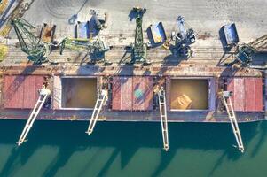 Top view from a drone of a large ship loading grain for export. Water transport photo