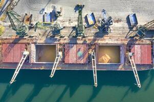 Top view from a drone of a large ship loading grain for export. Water transport photo