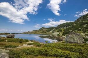 Landscape with mountain lake and big rock. photo