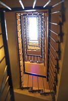 Up view of the staircase in the building. Vertical view photo