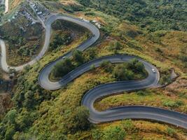 An aerial perspective showcases the intricate network of winding roads meandering through the hilly landscape at the break of dawn photo