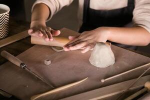 Children's Hands Creating Handmade Ceramics in Clay Close-Up photo