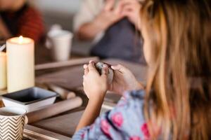 The girl is 7 years old blonde and does creative work with a ceramics studio and sculpts with clay photo