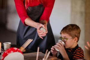 Young Boy with Glasses Engaged in Handmade Ceramics photo