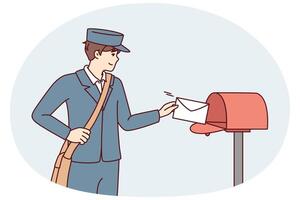 Man in postman uniform throws paper letter into metal mailbox located on street vector