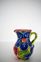a portrait image of a colourful mediterranean ceramic jug photo