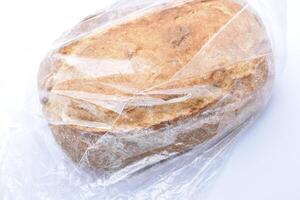 A fresh loaf of bread in a cellophane bag. photo