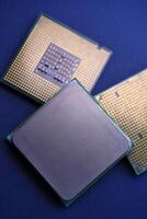 The shiny cover of the computer processor. Multiple processors on a blue background. Computer details. photo