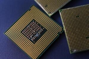 A computer processor on a blue background. Contacts on the processor case. photo