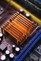 A copper radiator for cooling the chip on the computer board. Radio components.The computer's motherboard. photo