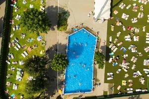 parte superior ver de un al aire libre sitio para personas a relajarse dónde allí es un nadando piscina y un lote de Dom camas foto