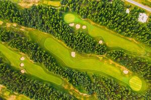Top view of the golf course located in a wooded area photo