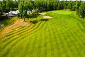 Top view of the golf course located in a wooded area photo