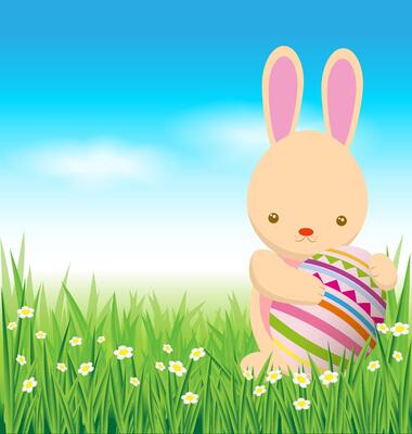 Rabbit and easter eggs on green grass